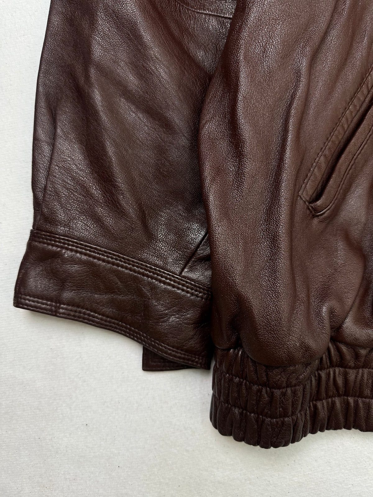 Close detail of the pockets and cuff on the size L burgundy leather harrington jacket
