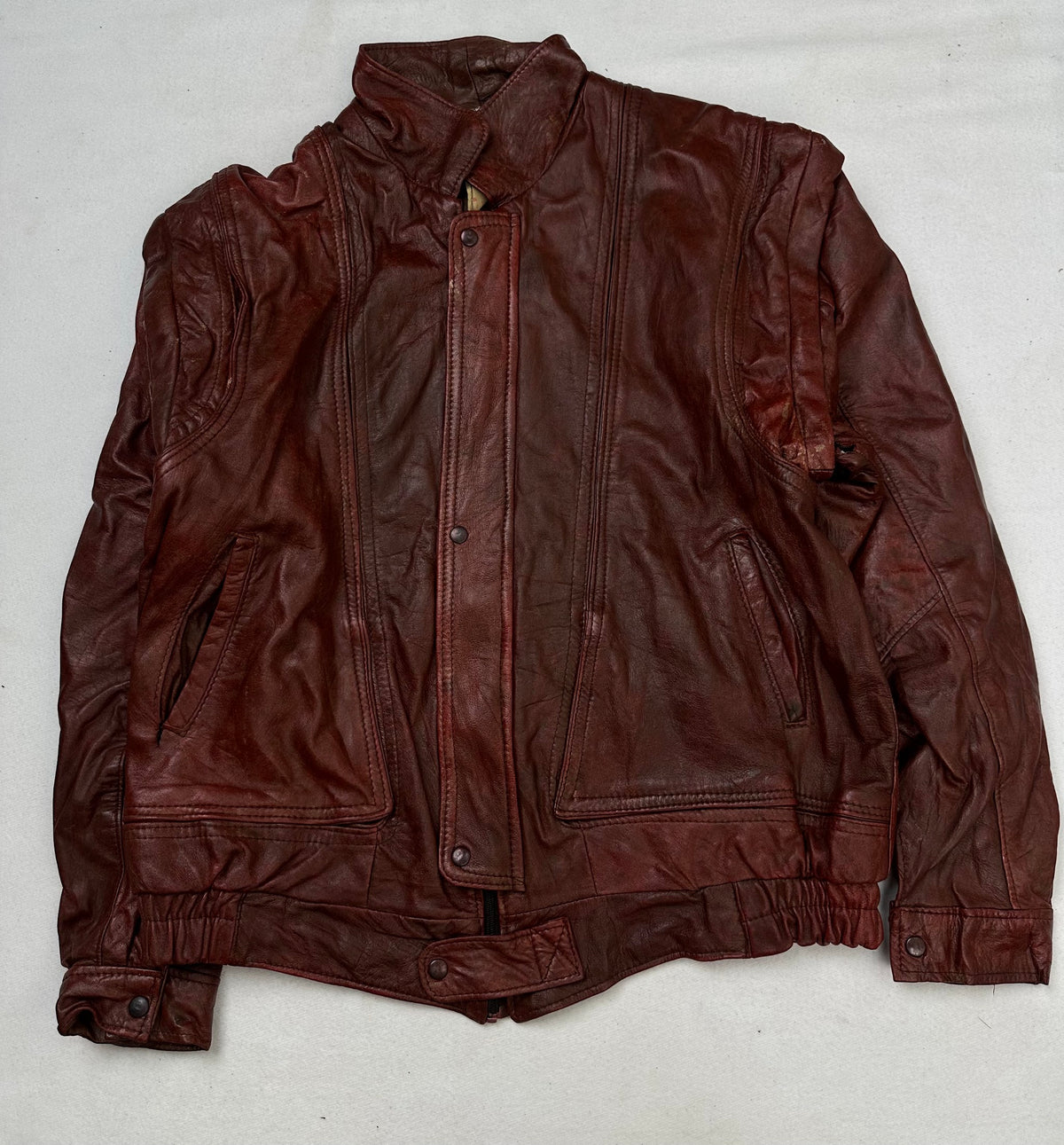 Front of the size L burgundy leather flight jacket, laid flat and unedited