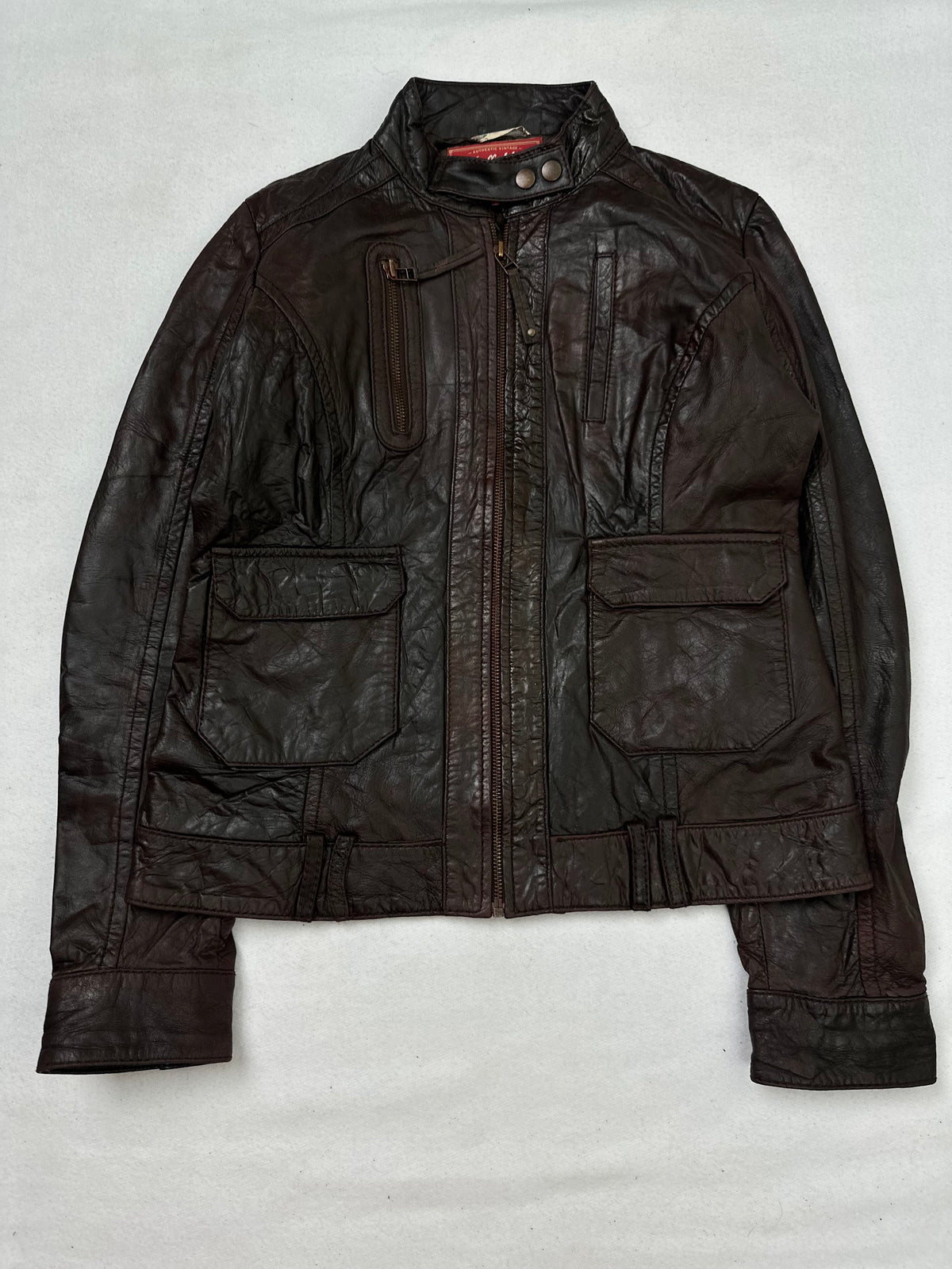 Front of the size XS brown leather cafe racer jacket, laid flat and unedited
