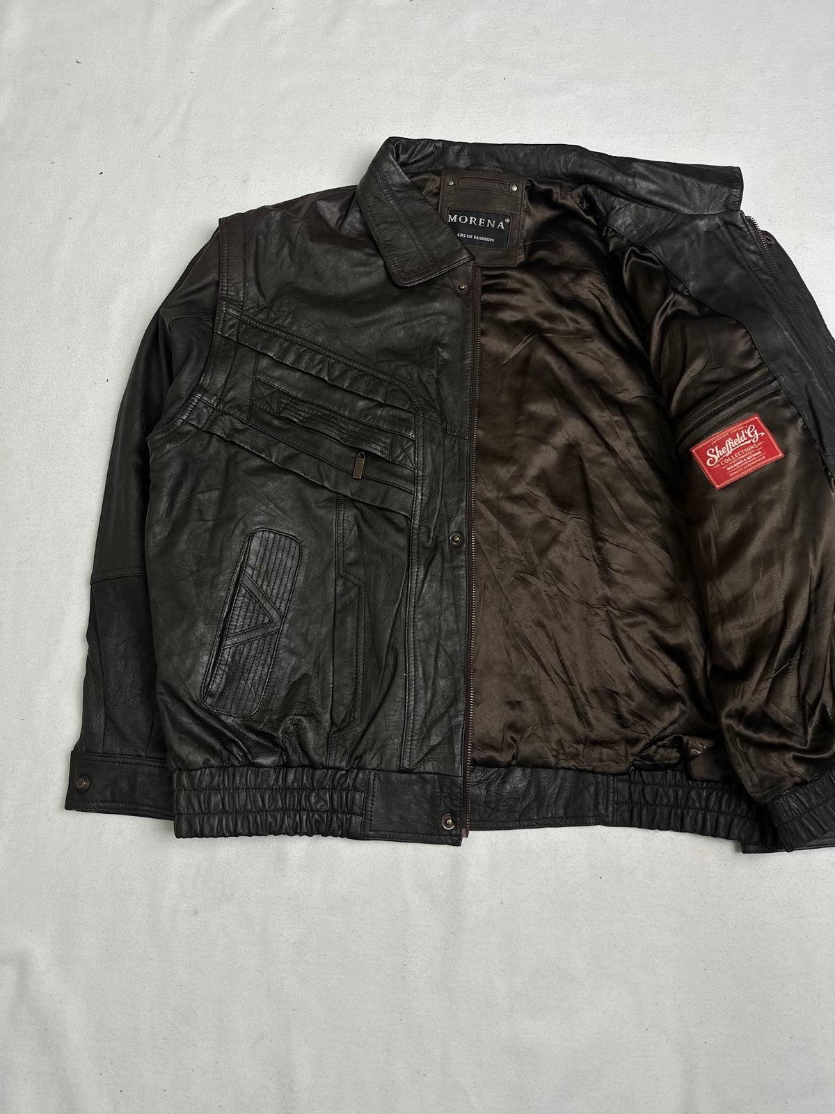 Angled zip chest pocket set under the braided leather yoke