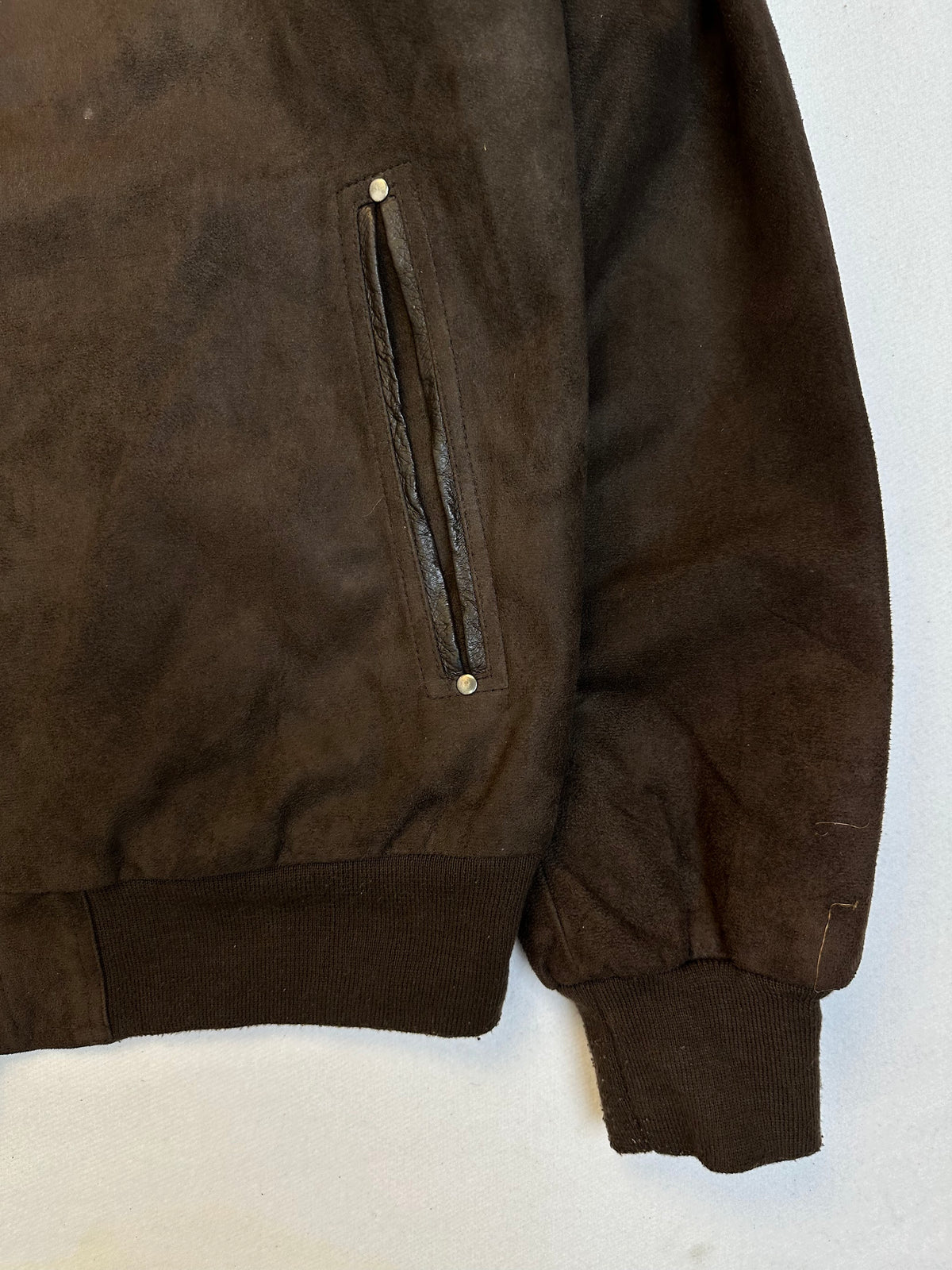 Side pocket and hem of the size L brown leather cafe racer jacket, up close