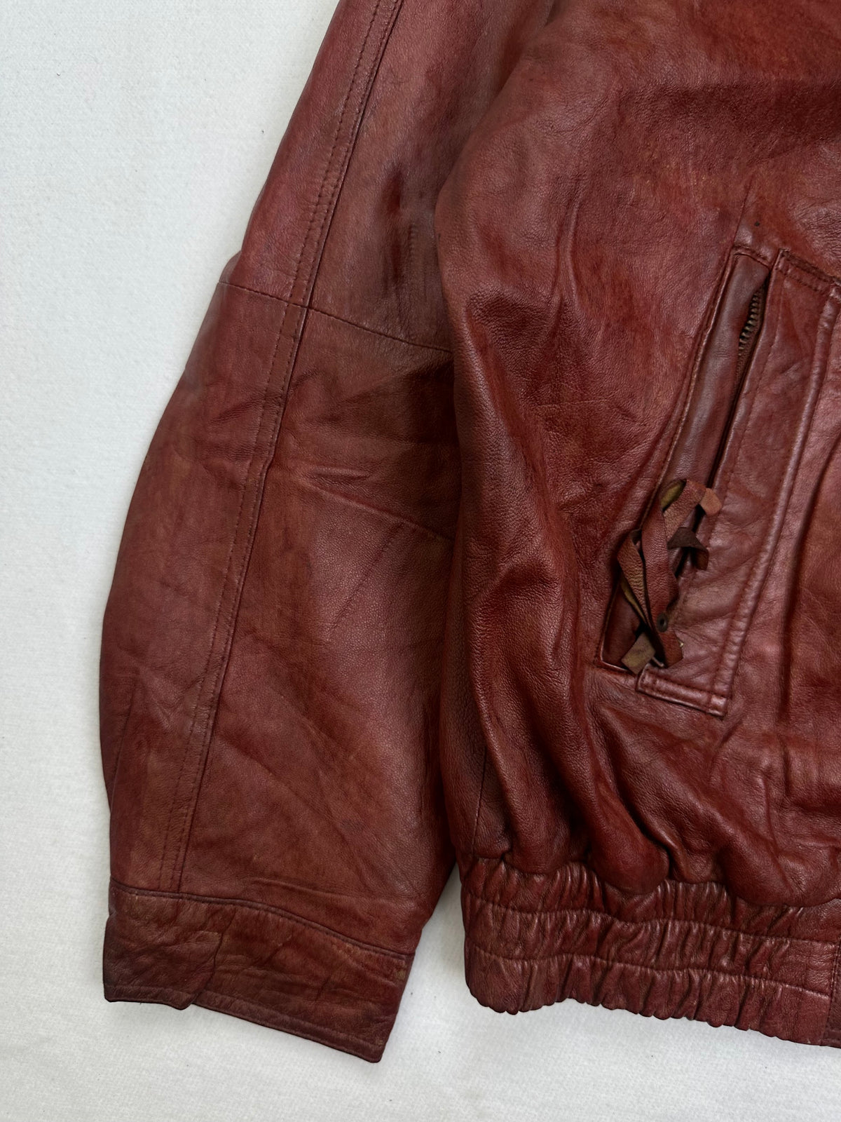 Close detail of the pockets and cuff on the size XL burgundy leather harrington jacket
