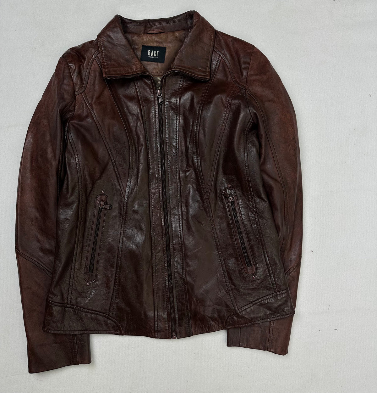 Front of the size S burgundy leather vintage jacket, laid flat and unedited