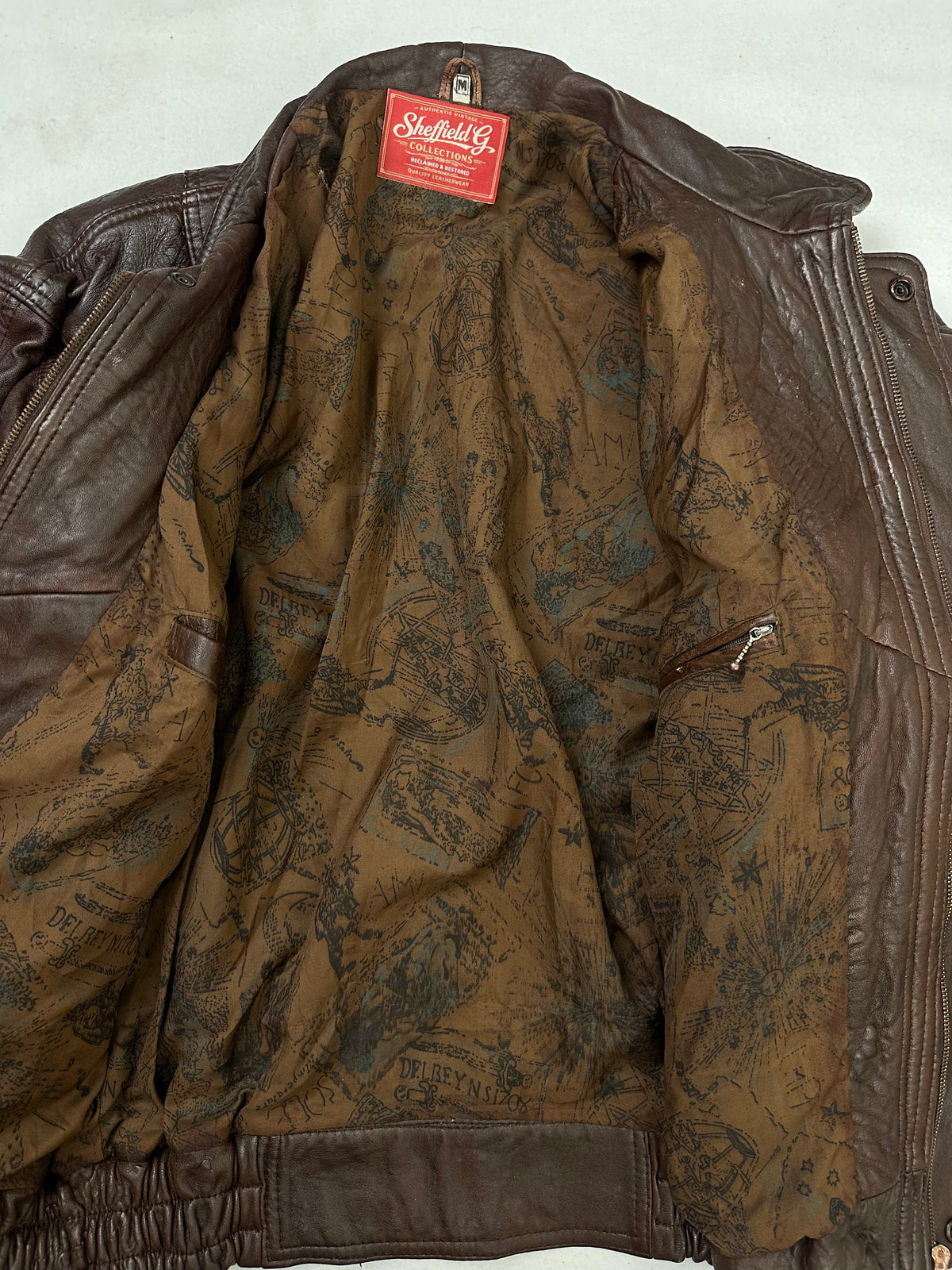 The size L burgundy leather flight jacket opened to show the lining