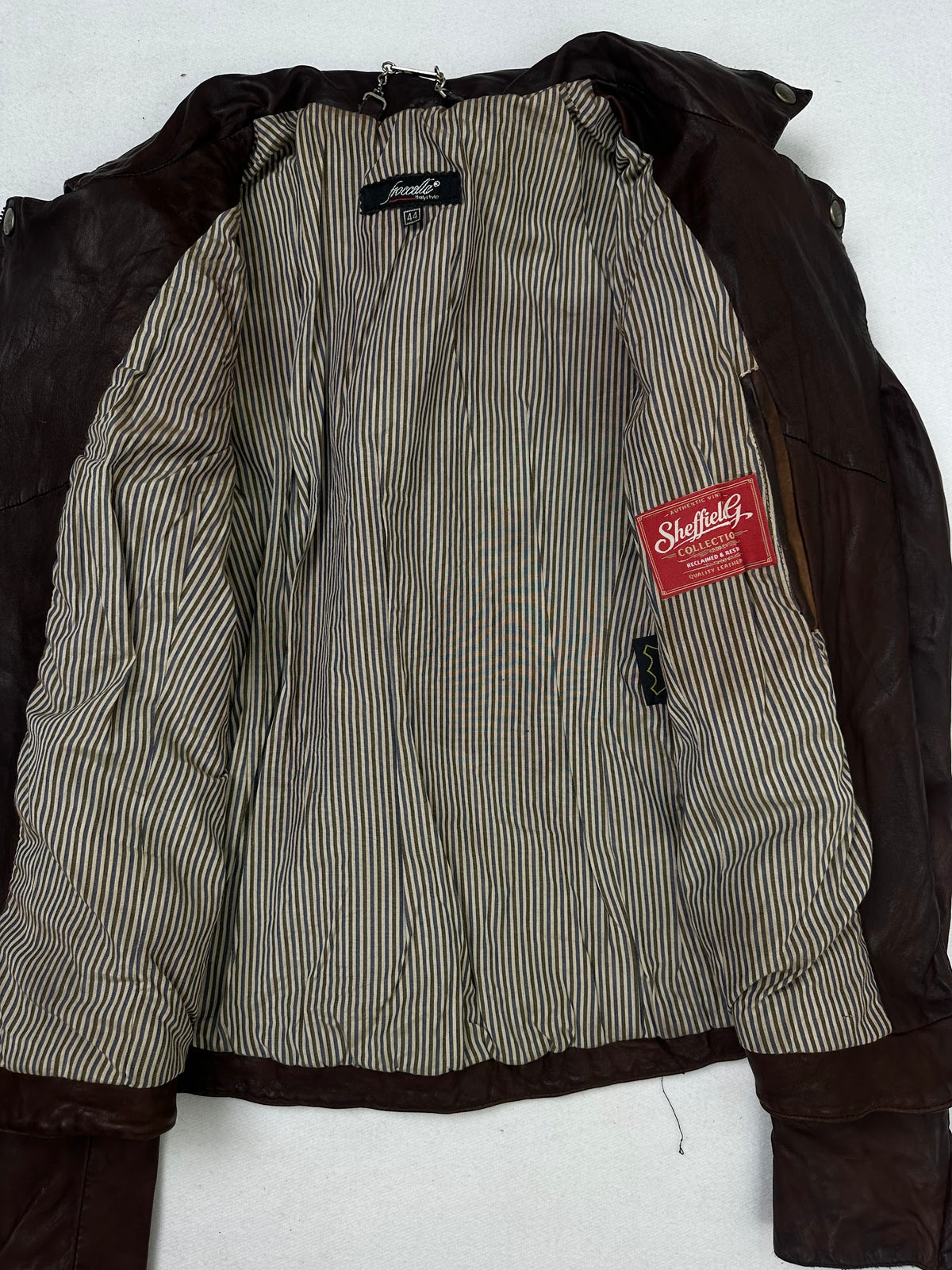 The size S burgundy leather biker jacket opened to show the lining