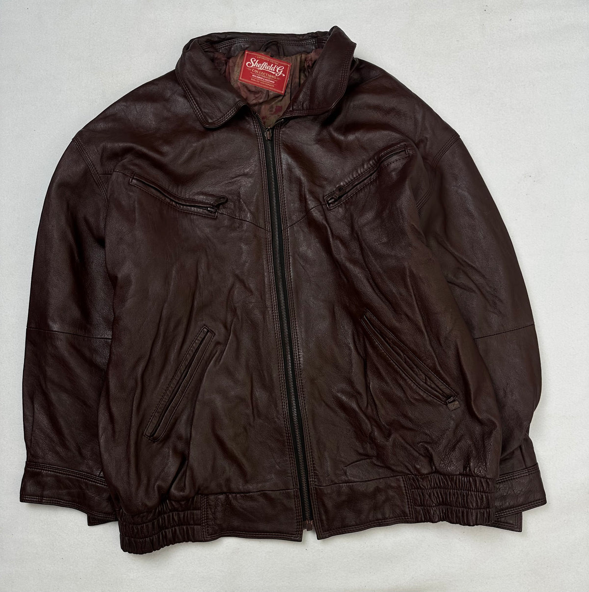 Front of the size L burgundy leather harrington jacket, laid flat and unedited