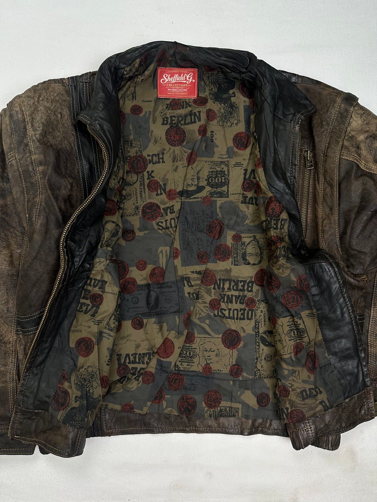 Vertical zip chest pocket beside a slanted welt hand pocket
