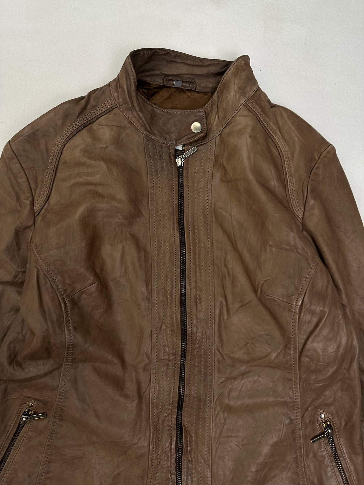 Zipped slant pocket at the hip above the plain open hem