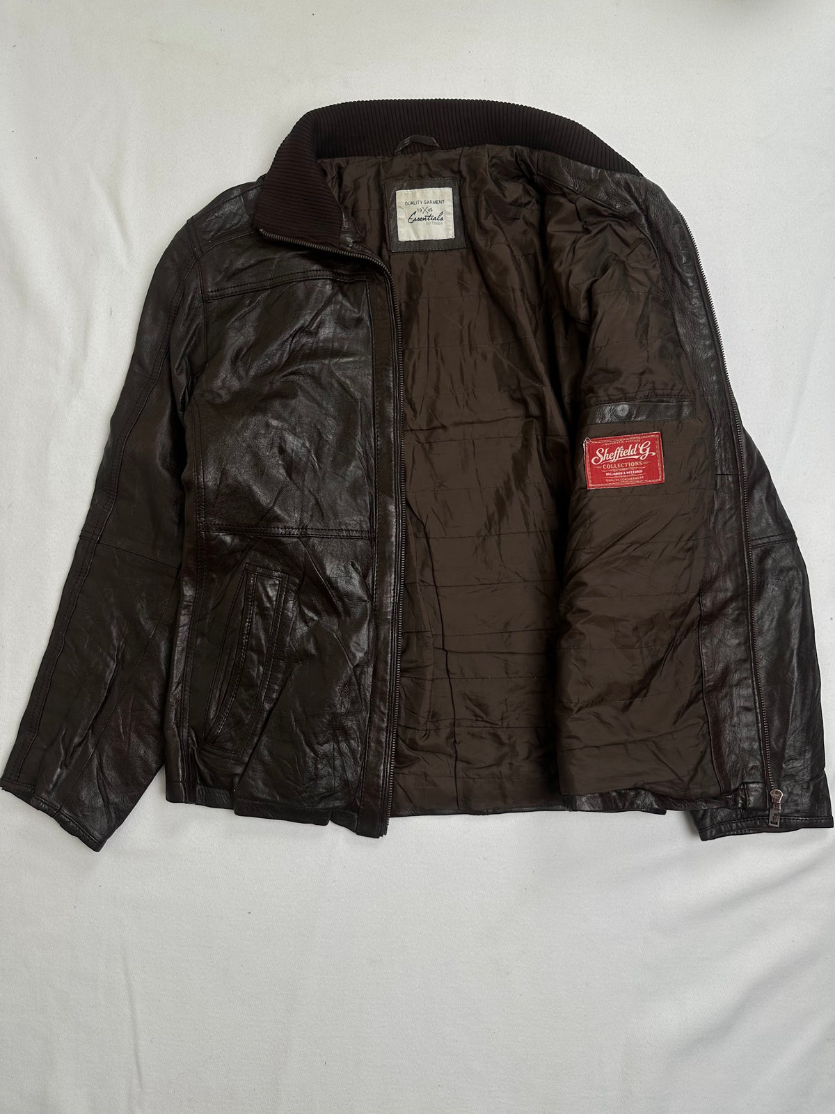 Vertical zip chest pocket with a red pull beside the leather waist band