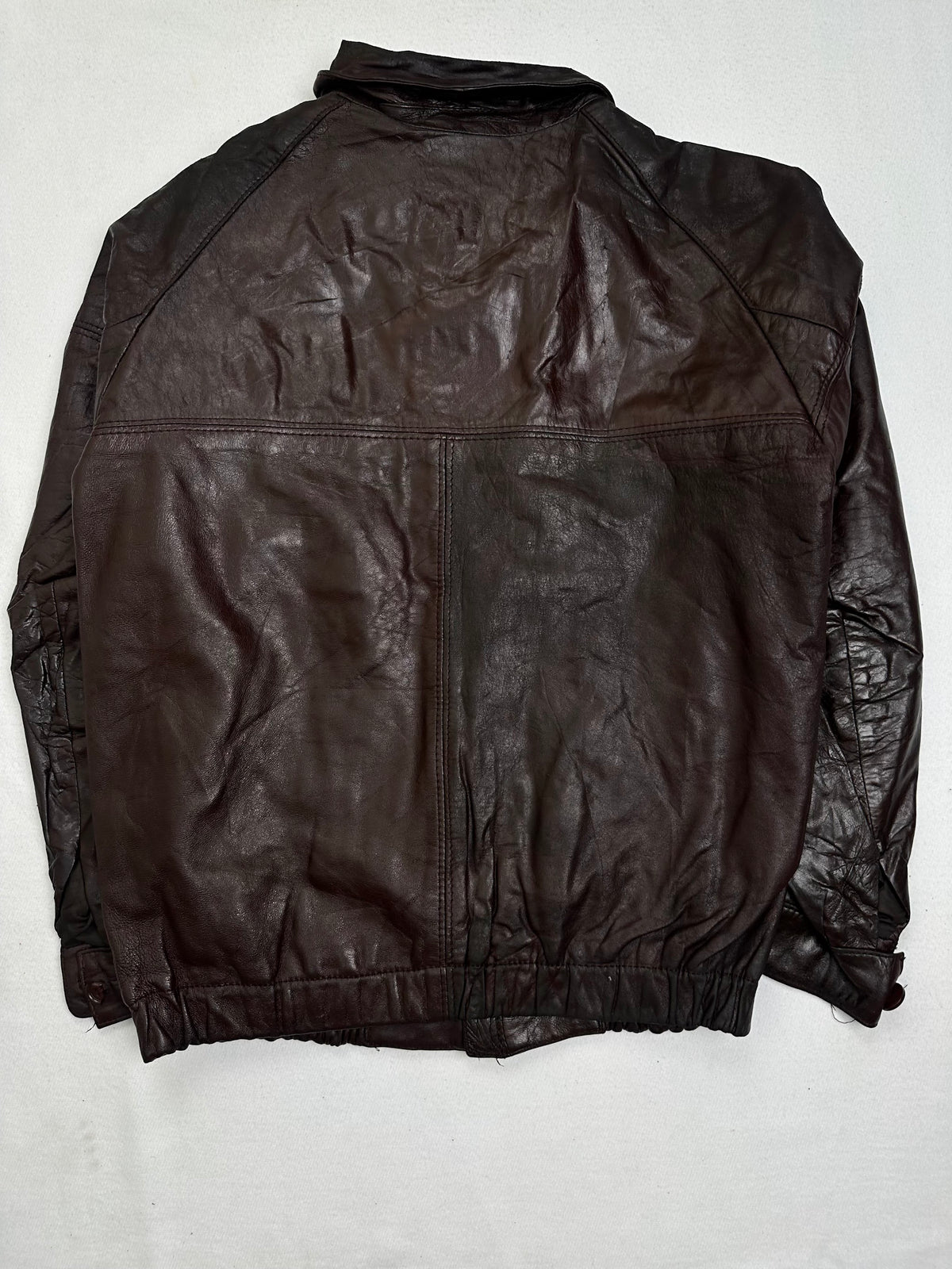 Back of the size M burgundy leather harrington jacket, laid flat