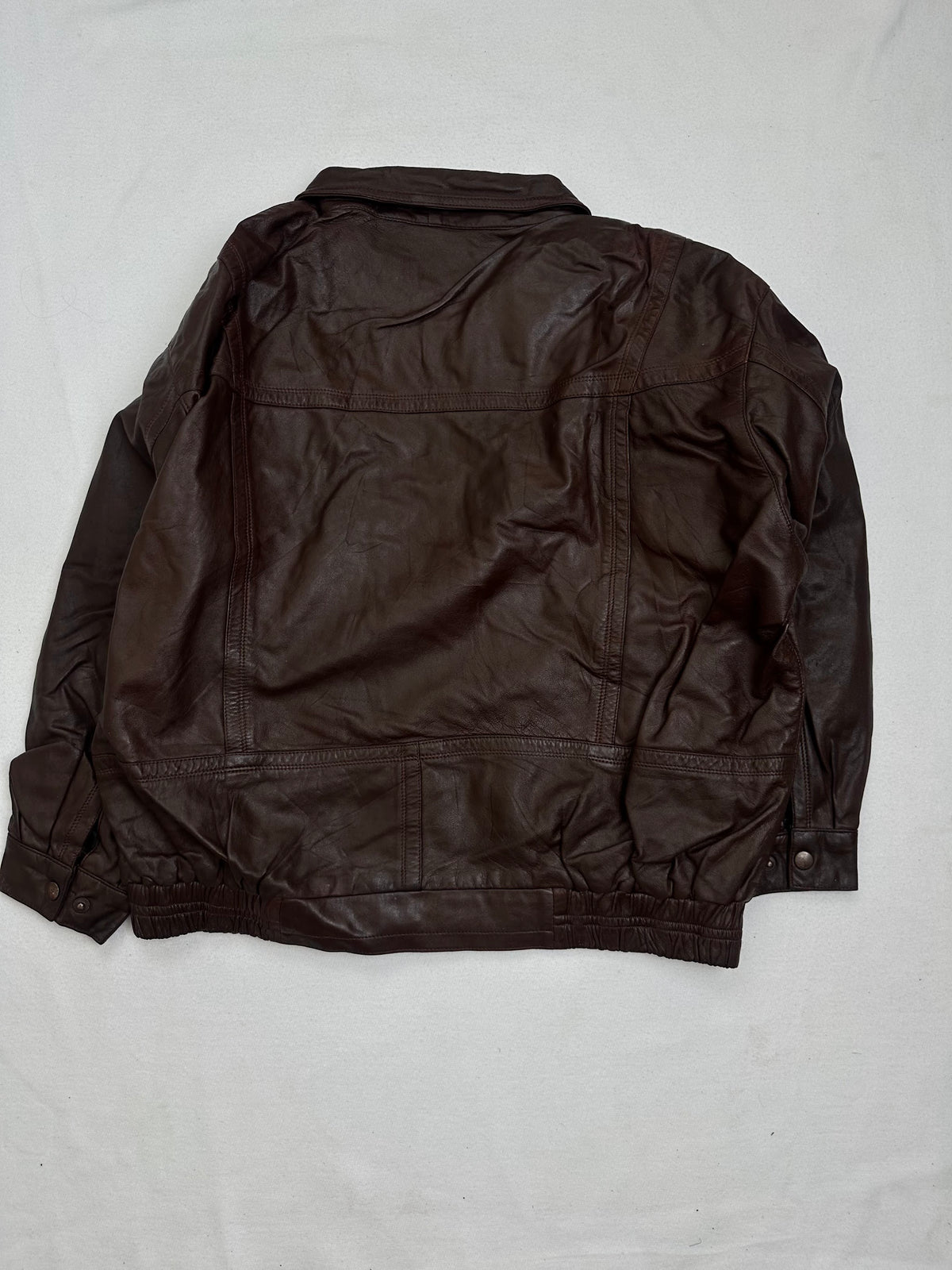 Back of the size L burgundy leather flight jacket, laid flat