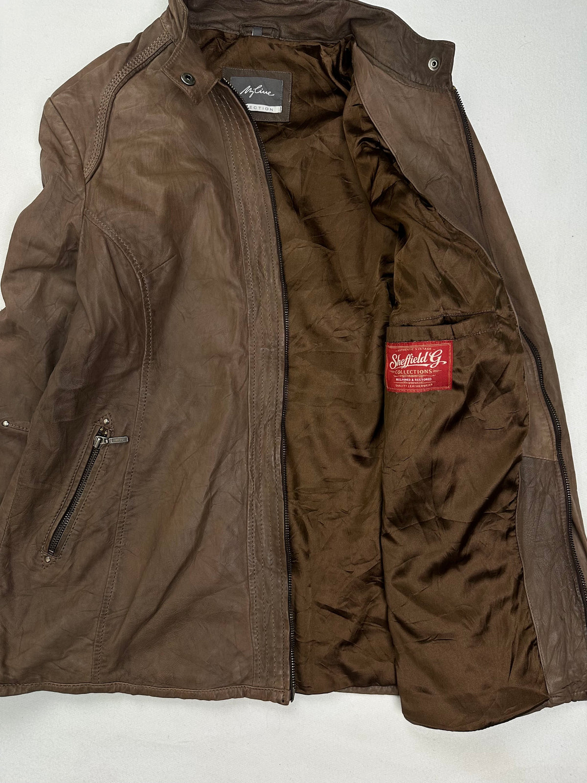 Dark olive brown lining shown with the jacket held open
