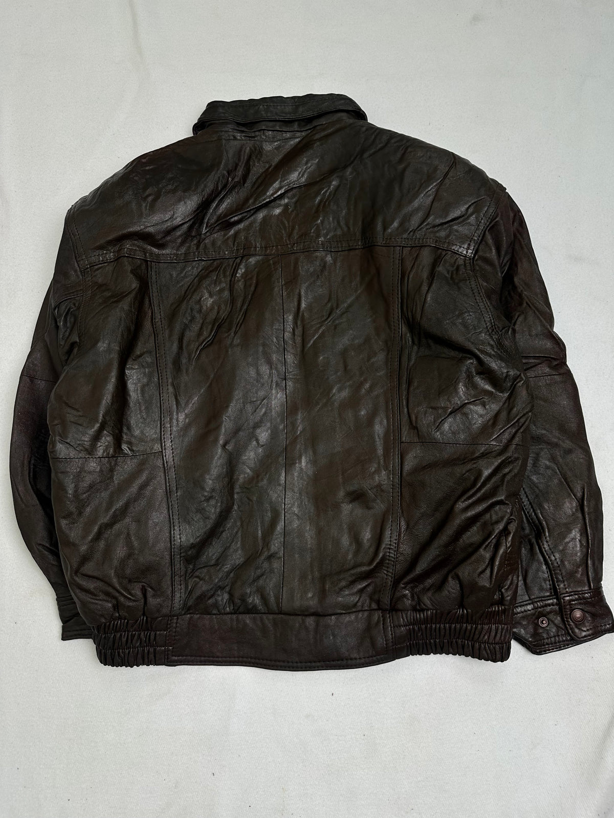 Back and sleeves showing creasing with lightening along the crease lines
