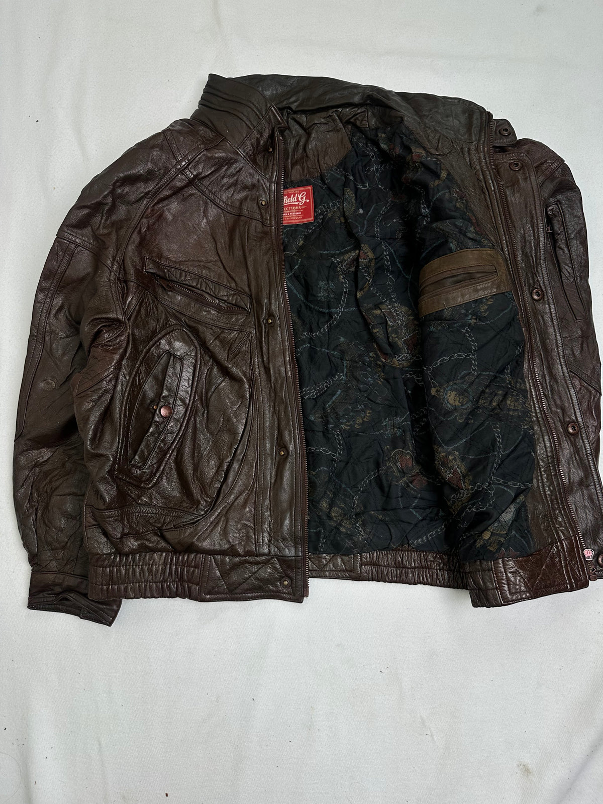 Dark navy-black quilted lining with an allover printed pattern