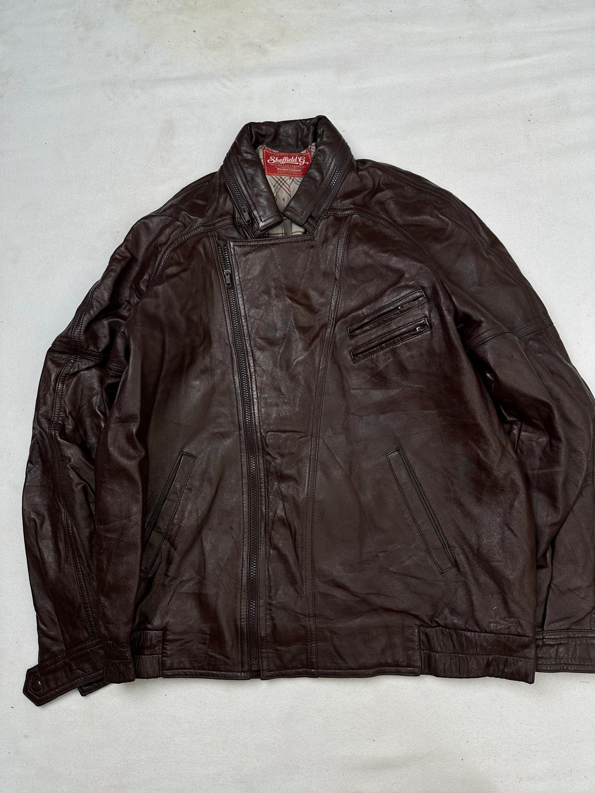 Front of the size L burgundy leather biker jacket, laid flat and unedited