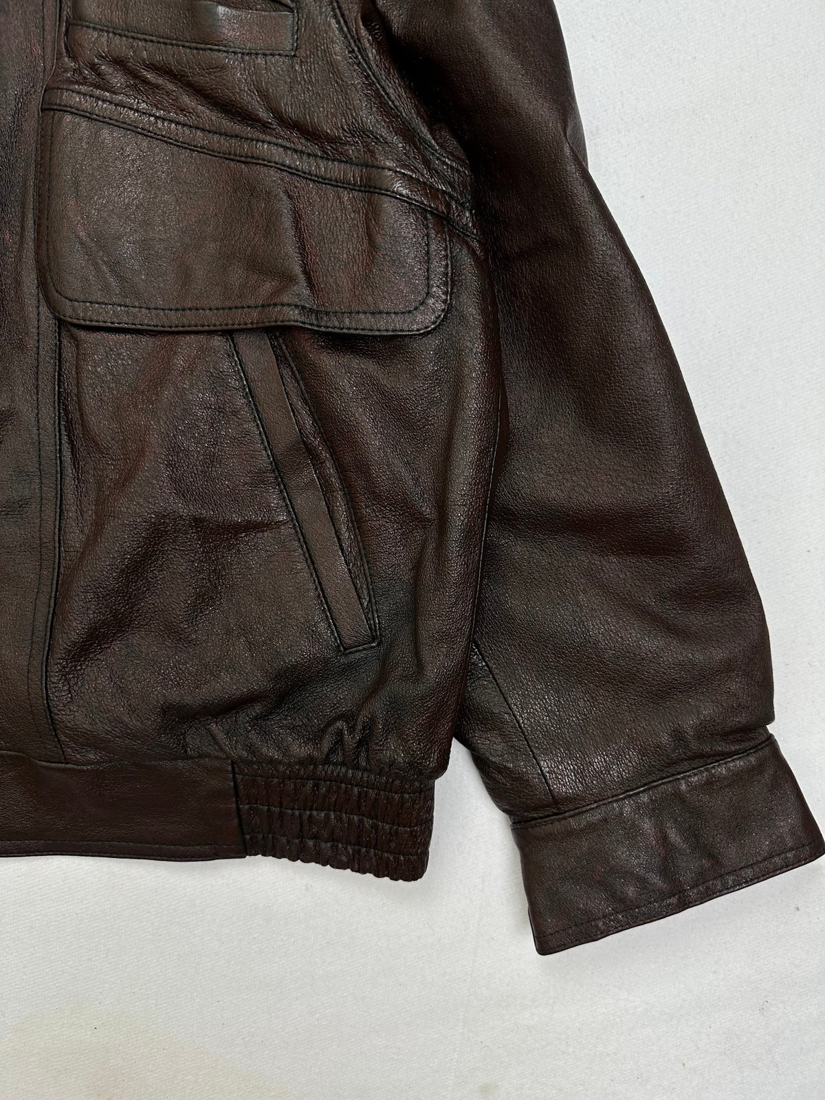 Side pocket and hem of the size L brown leather flight jacket, up close