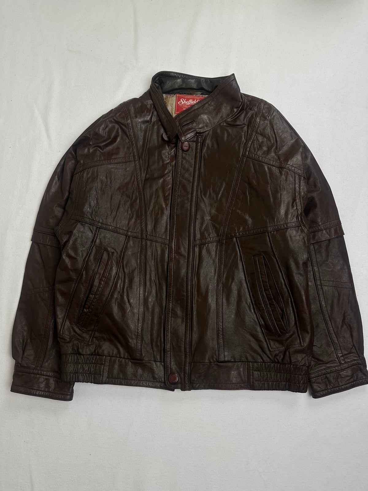 Back of the size L brown vintage jacket laid flat