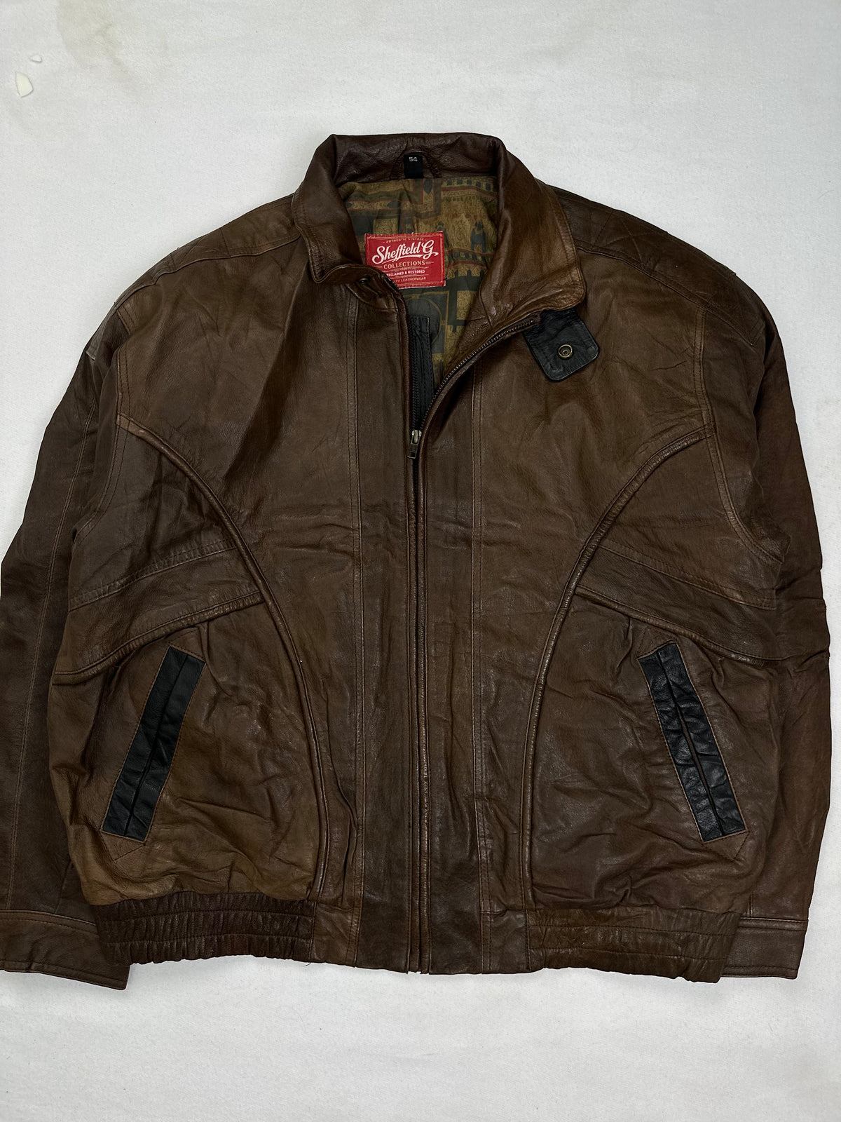 Back of the size L brown harrington jacket laid flat
