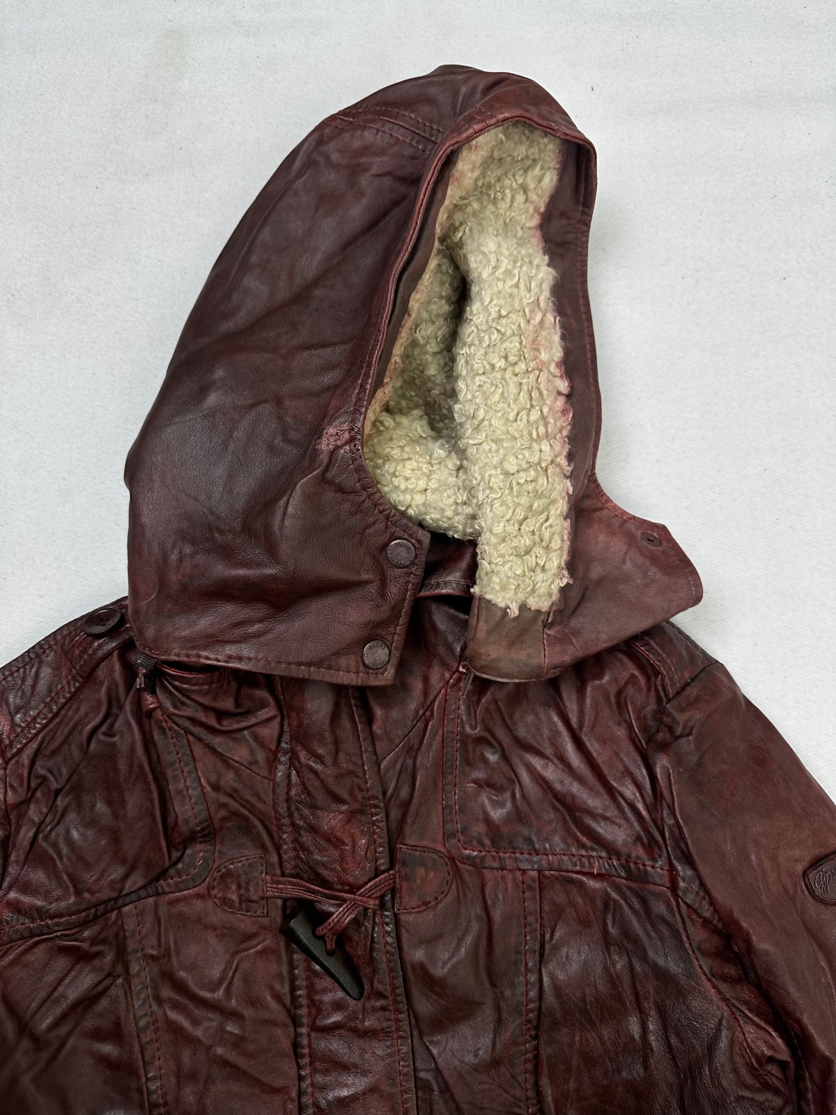Inside of the collar on the size L burgundy leather hooded jacket
