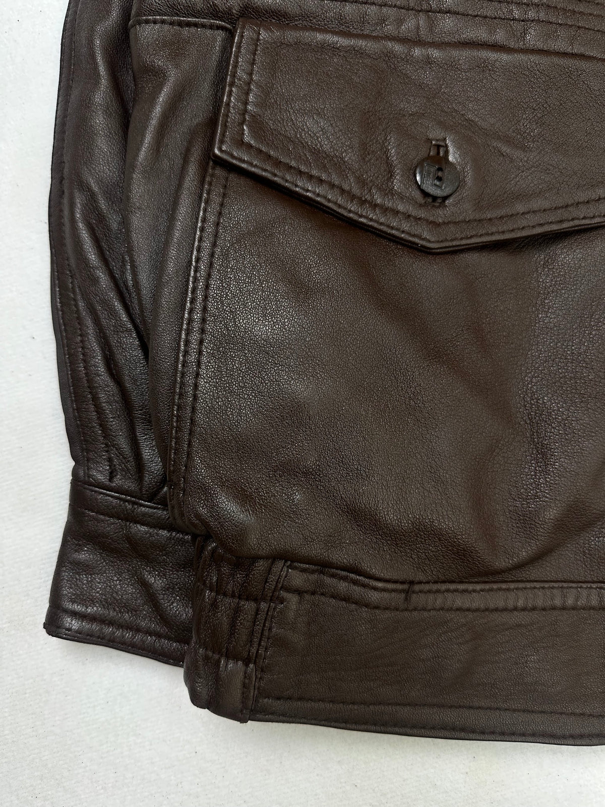 Close detail of the pockets and cuff on the size L brown leather flight jacket