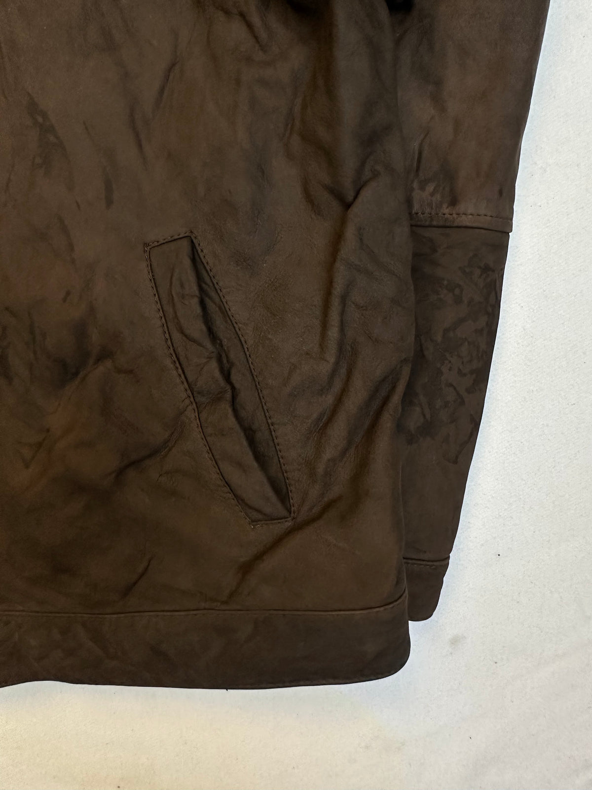 Side pocket and hem of the size XL brown leather vintage jacket, up close