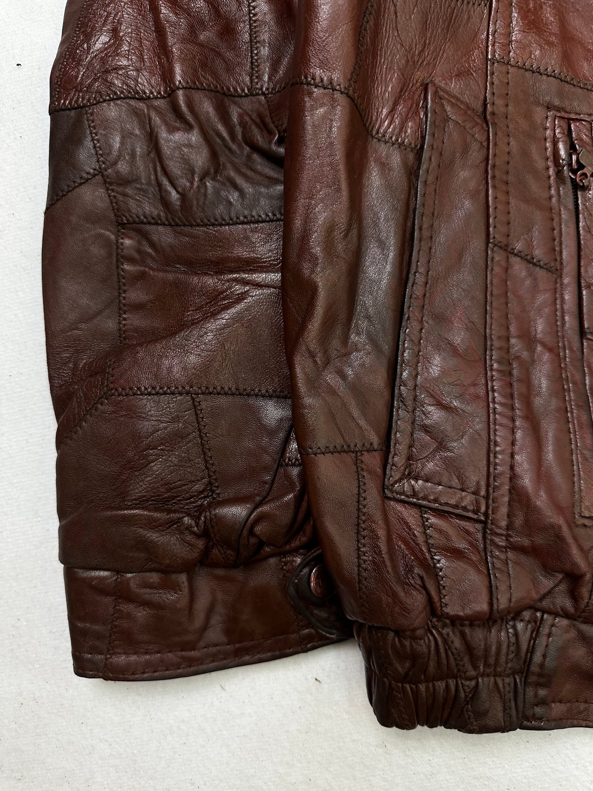 Close detail of the pockets and cuff on the size XL burgundy leather flight jacket