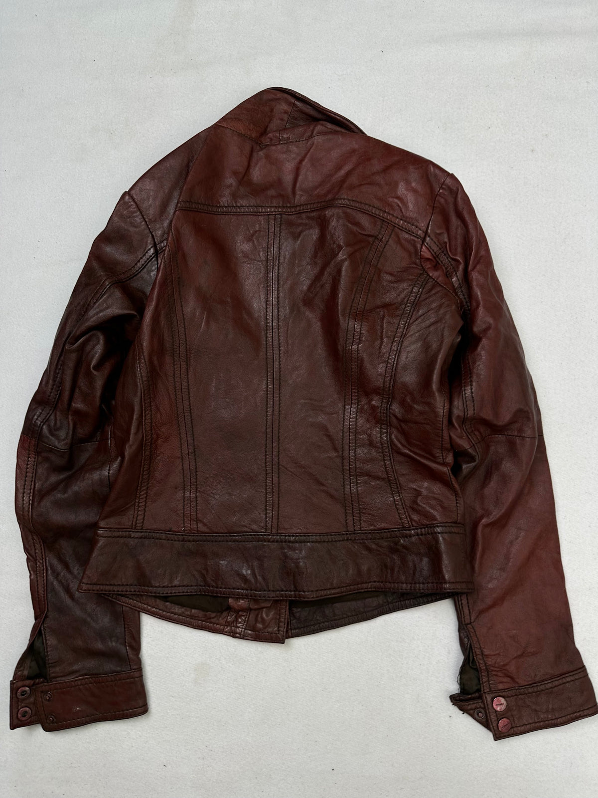 Back of the size S burgundy leather cafe racer jacket, laid flat