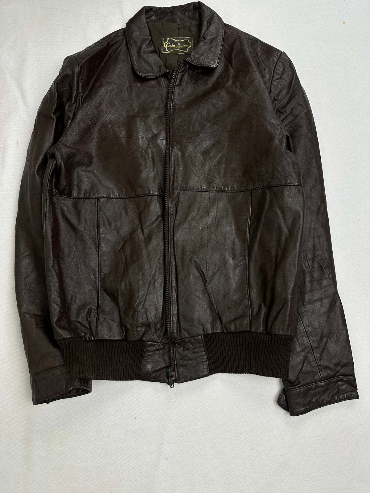 Olive nylon lining shown with the brown flight jacket held open