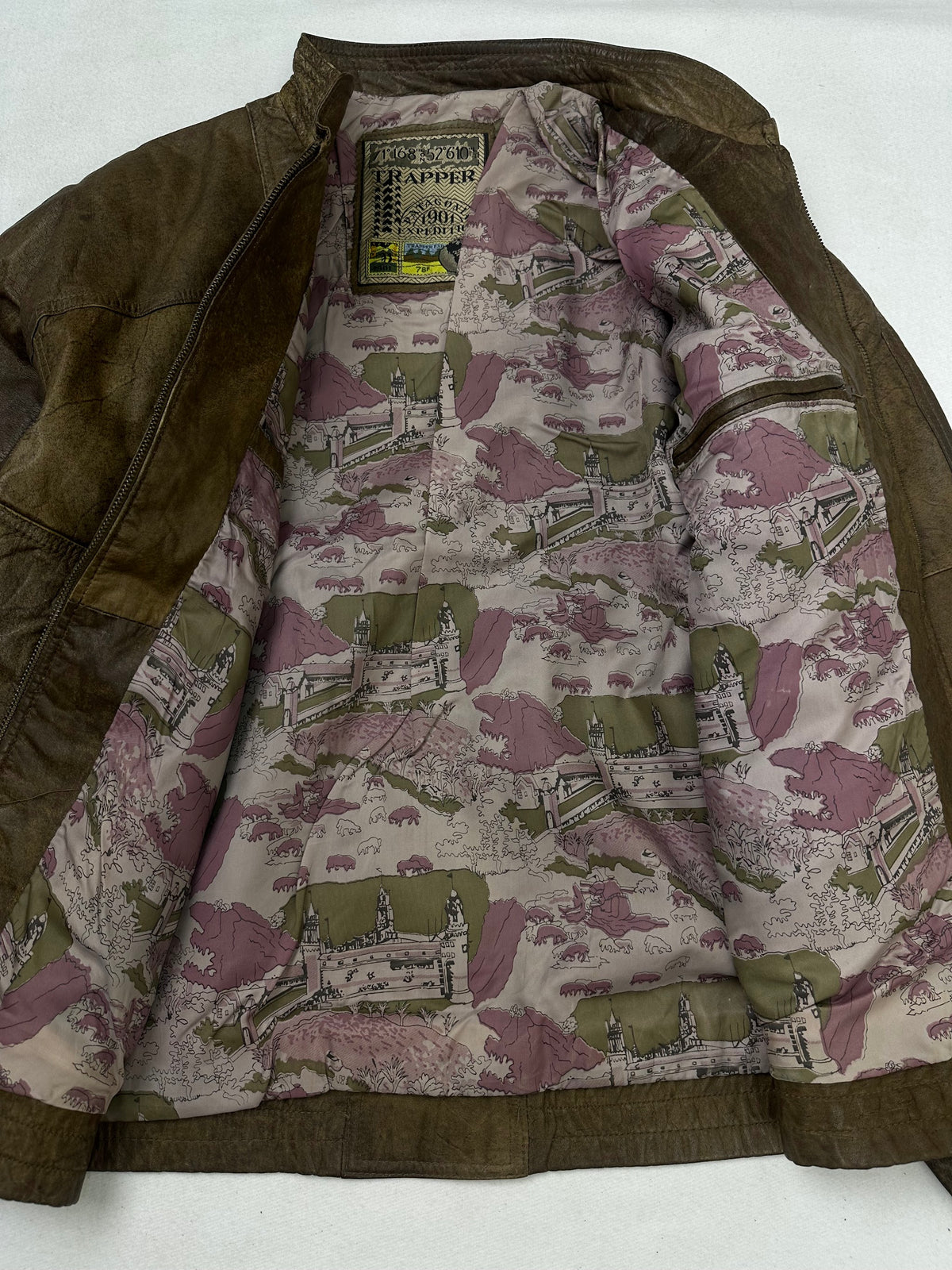 The size L brown leather cafe racer jacket opened to show the lining