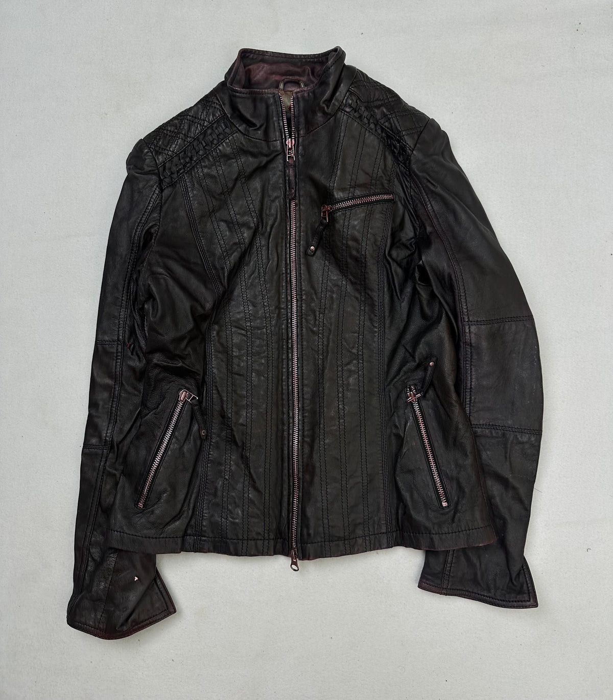 Front of the size S burgundy leather cafe racer jacket, laid flat and unedited