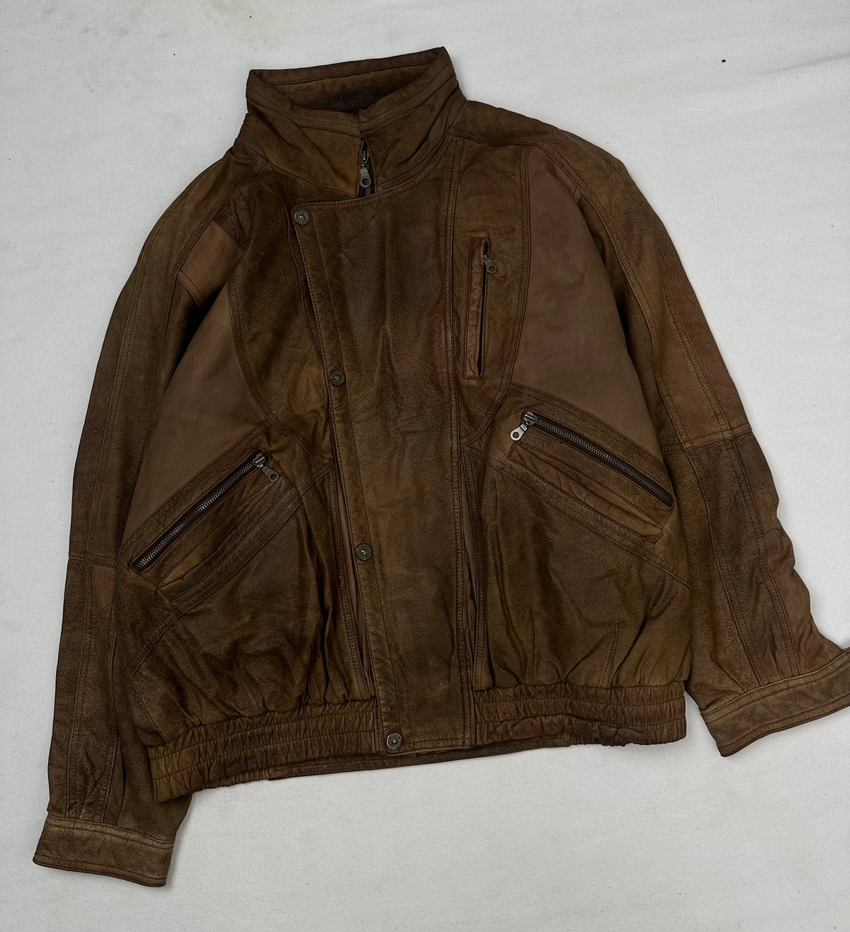 Front of the size XL brown leather flight jacket, laid flat and unedited