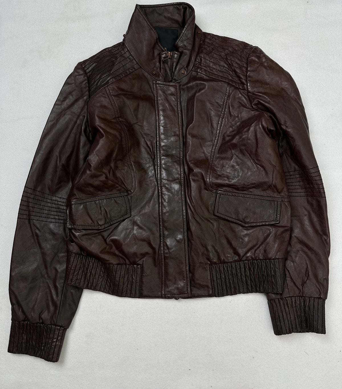 Front of the size S burgundy leather flight jacket, laid flat and unedited