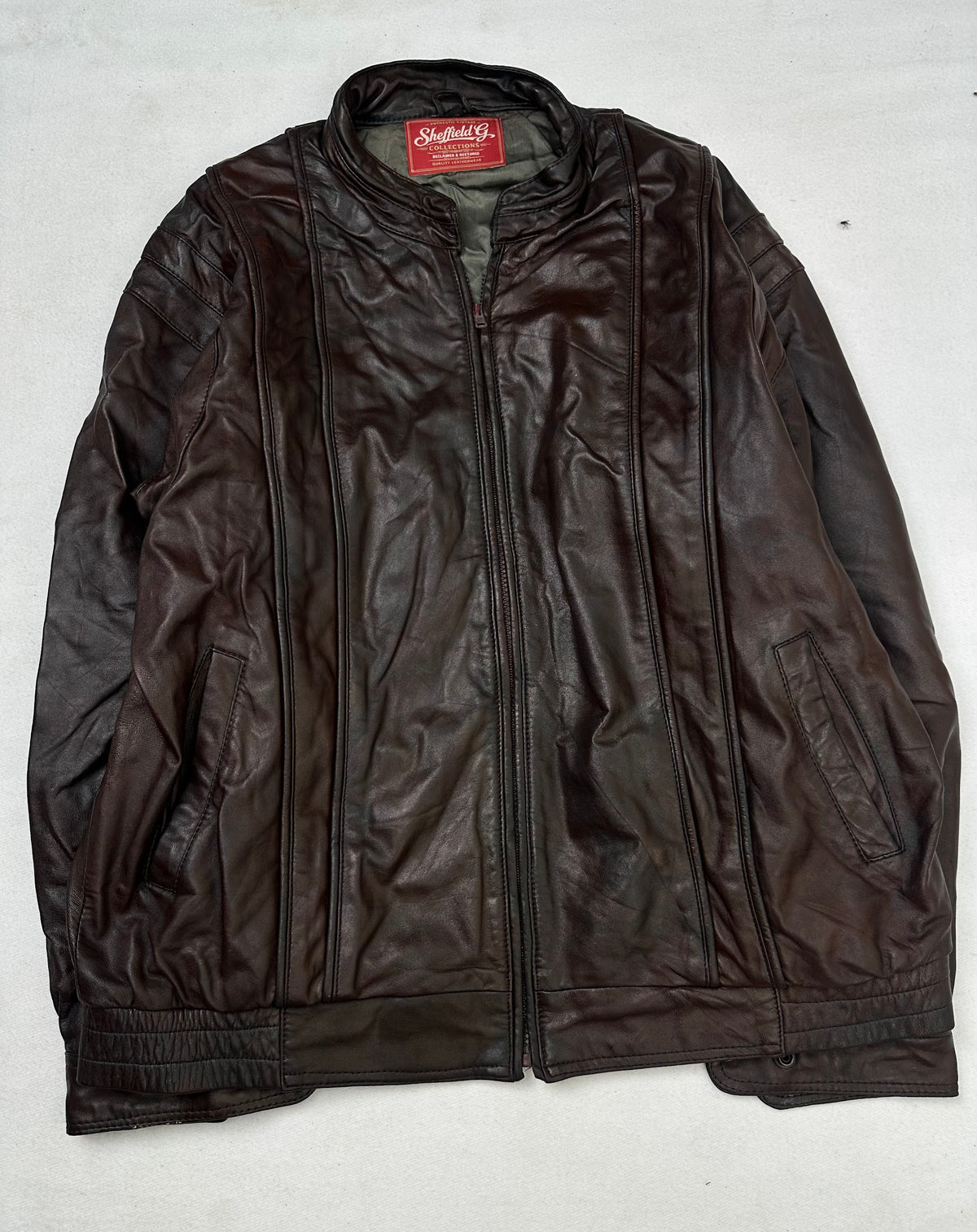 Front of the size L burgundy leather cafe racer jacket, laid flat and unedited