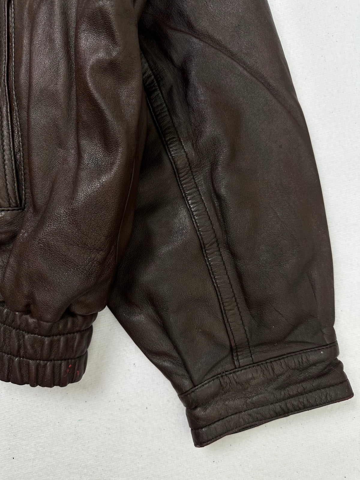 Close detail of the pockets and cuff on the size L burgundy leather flight jacket