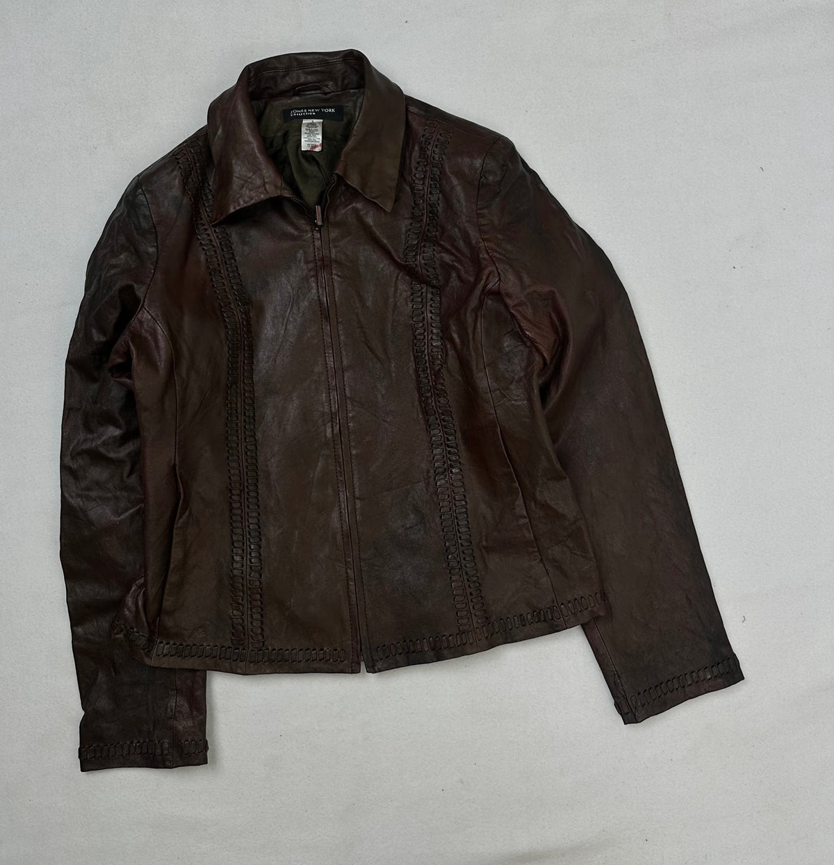 Front of the size S burgundy leather vintage jacket, laid flat and unedited
