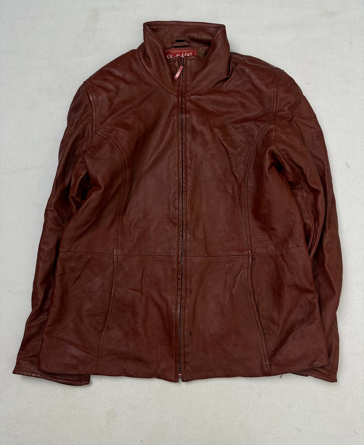 Front of the size S burgundy leather cafe racer jacket, laid flat and unedited