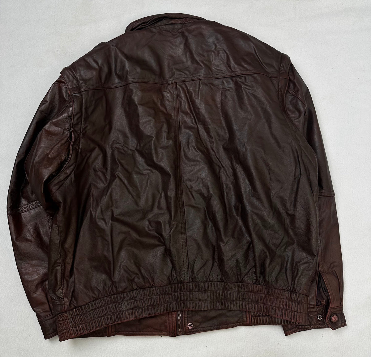 Back of the size L burgundy leather flight jacket, laid flat