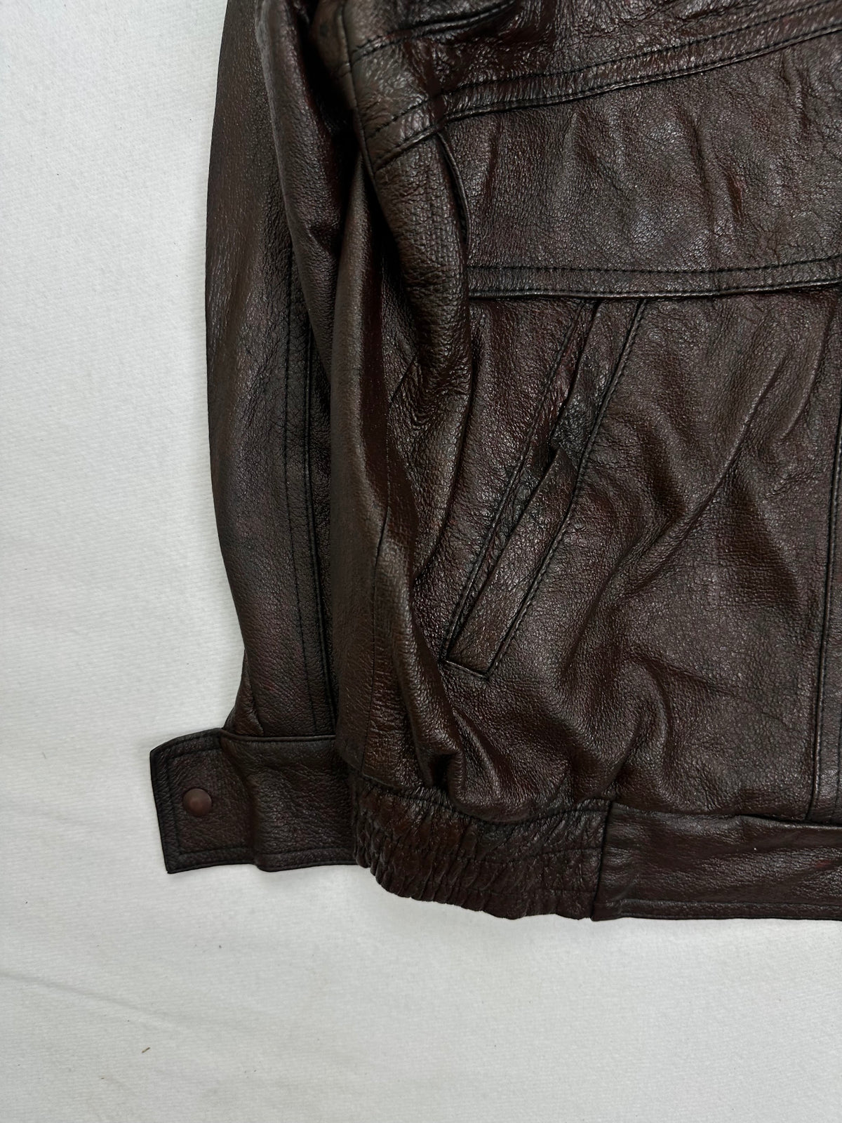 Close detail of the pockets and cuff on the size L brown leather flight jacket
