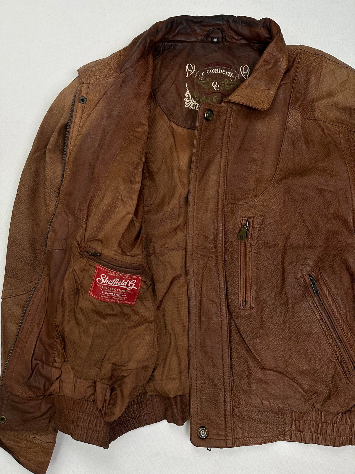 Vertical zip chest pocket above a slanted zip hand pocket