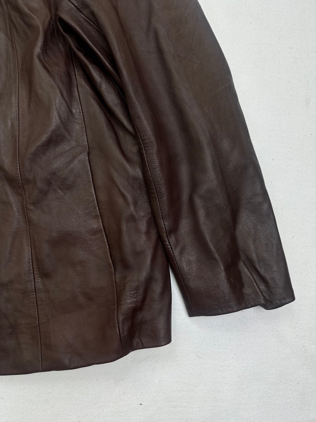 Side pocket and hem of the size L burgundy leather vintage jacket, up close