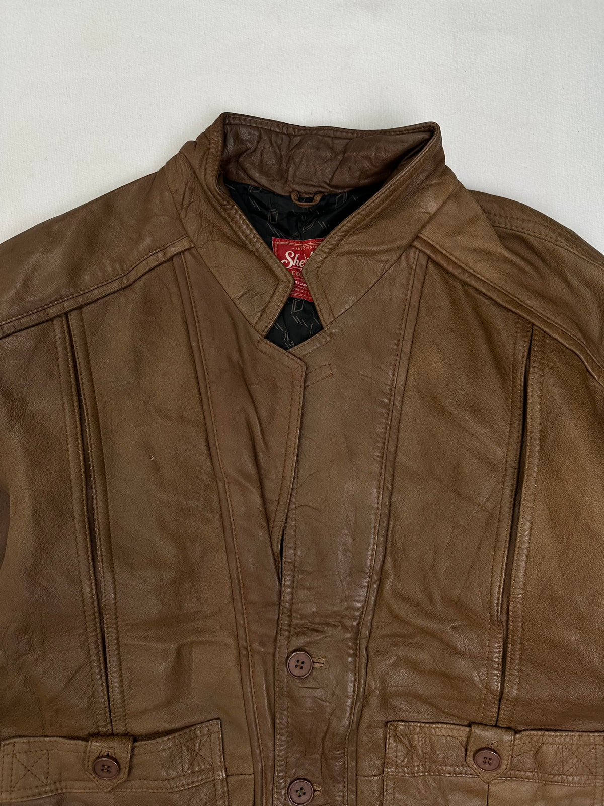 Buttoned tab on a large flap patch pocket at the hip
