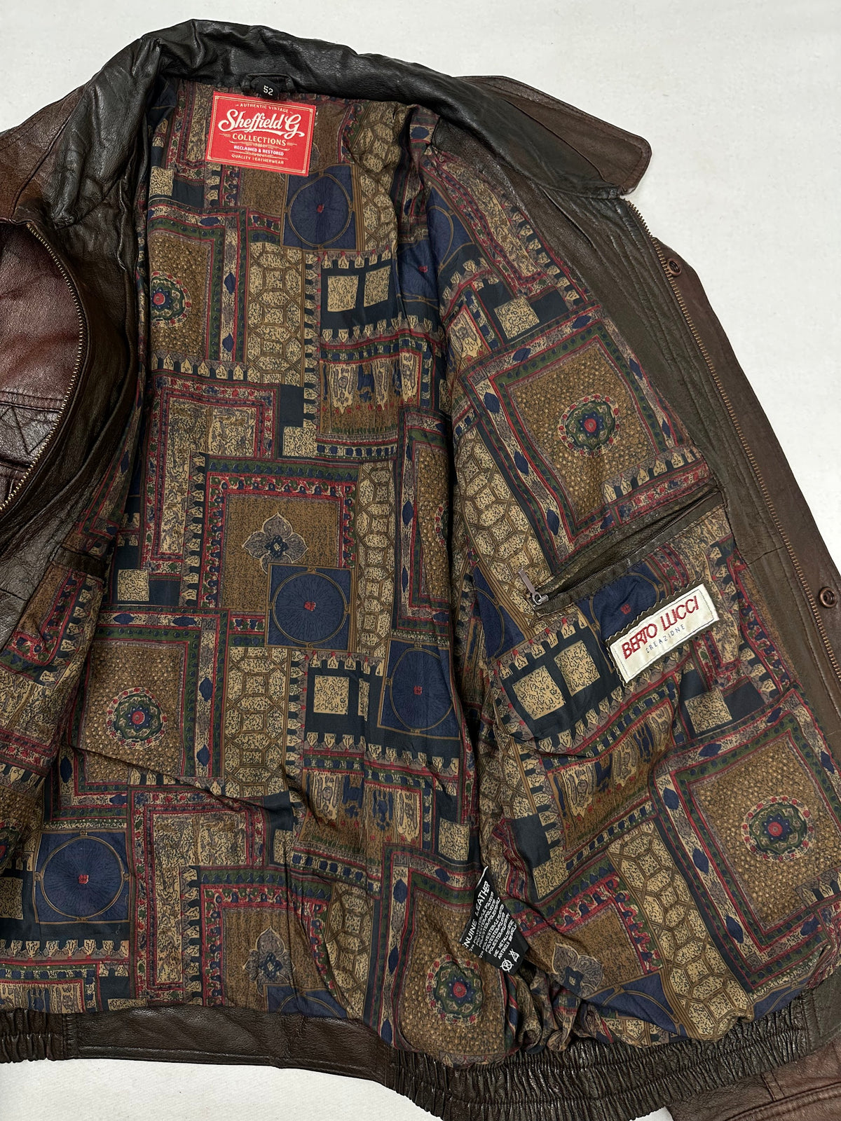 The size L burgundy leather flight jacket opened to show the lining