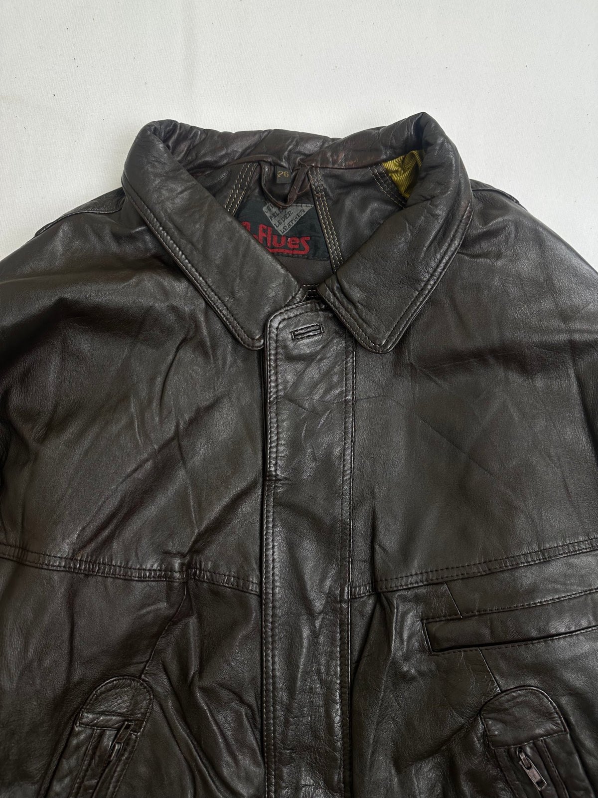 Mustard satin lining shown with the brown harrington held open