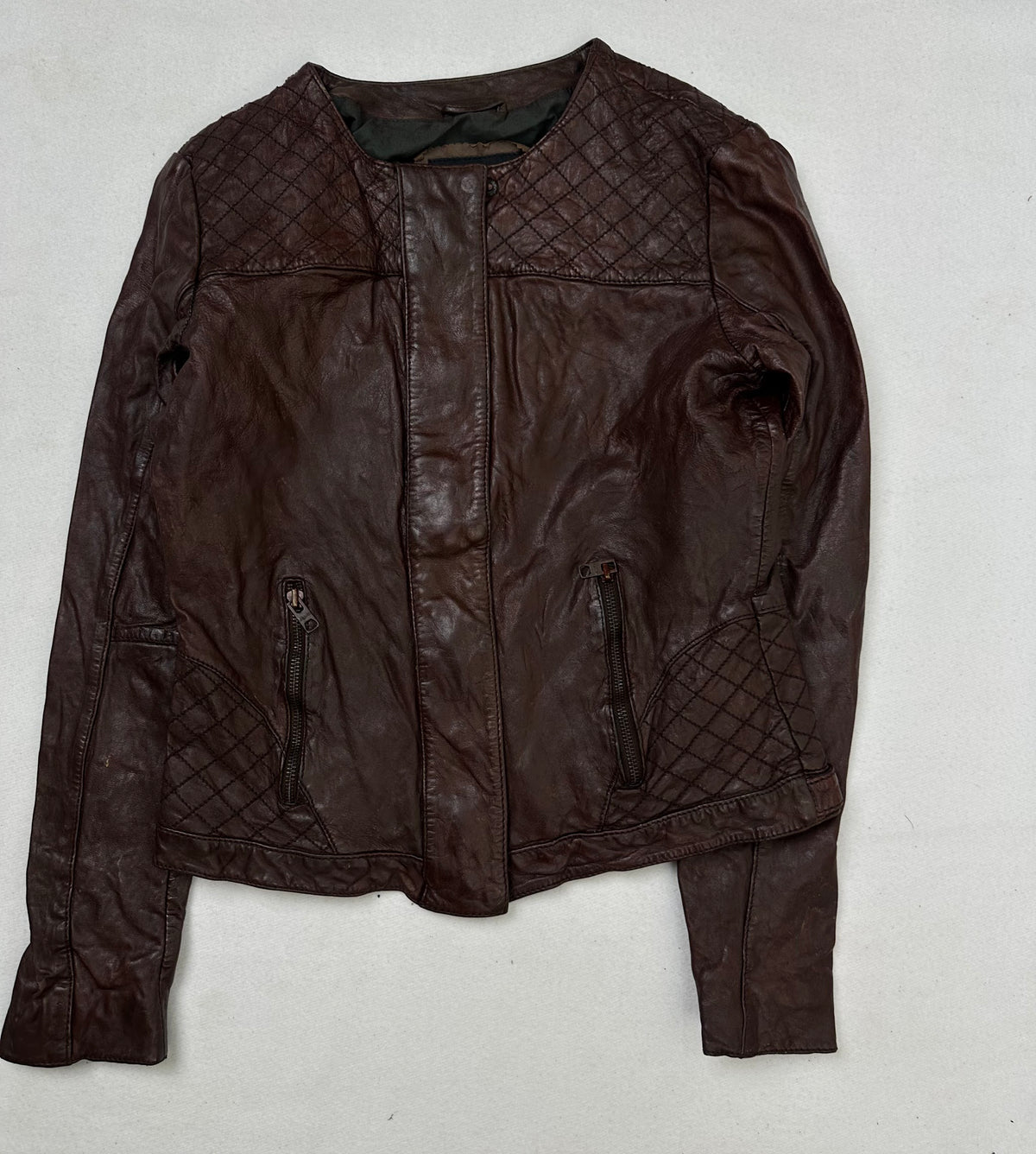 Front of the size S burgundy leather vintage jacket, laid flat and unedited