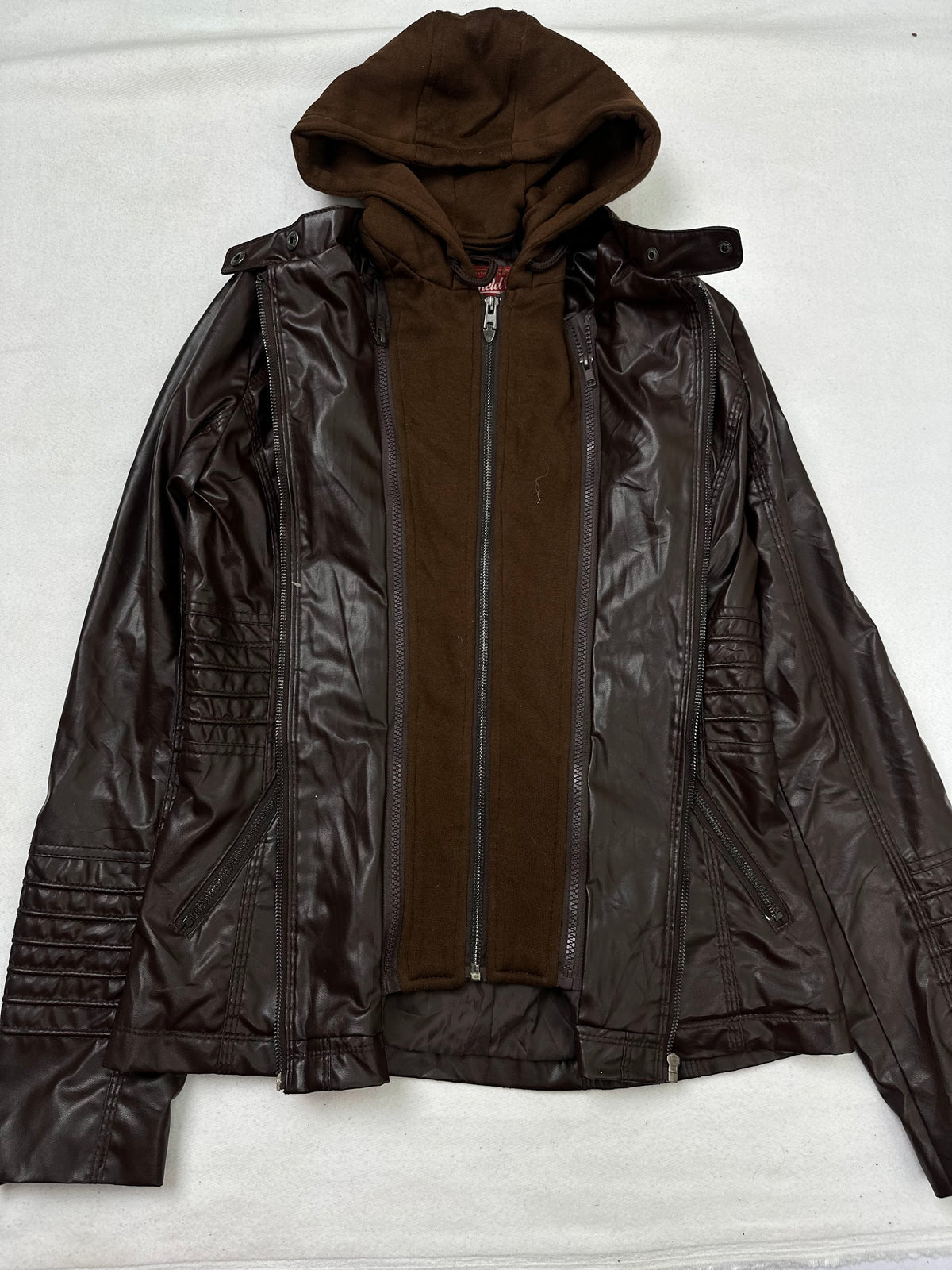 Side pocket and hem of the size M brown leather hooded jacket, up close