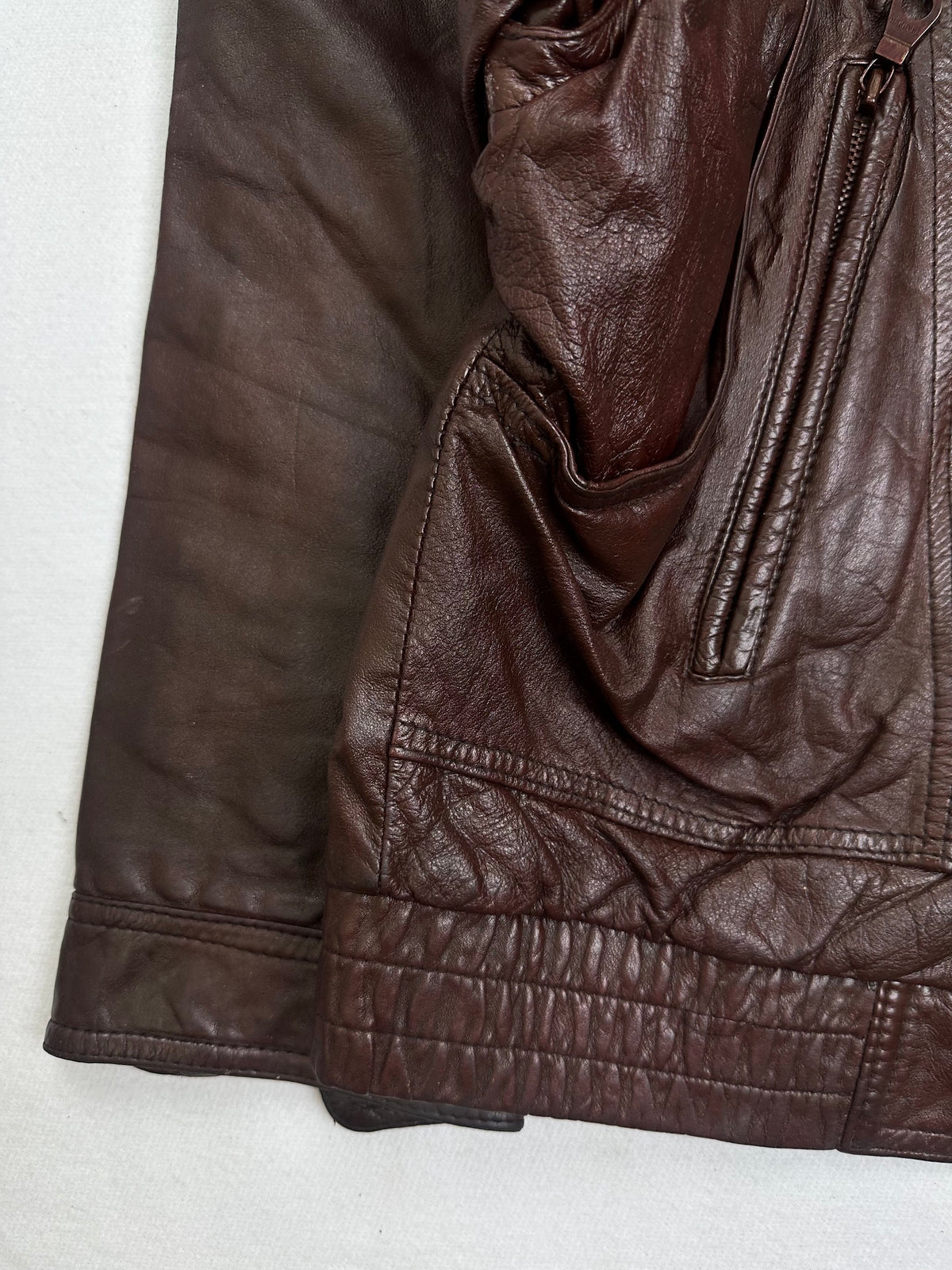 Close detail of the pockets and cuff on the size L burgundy leather flight jacket