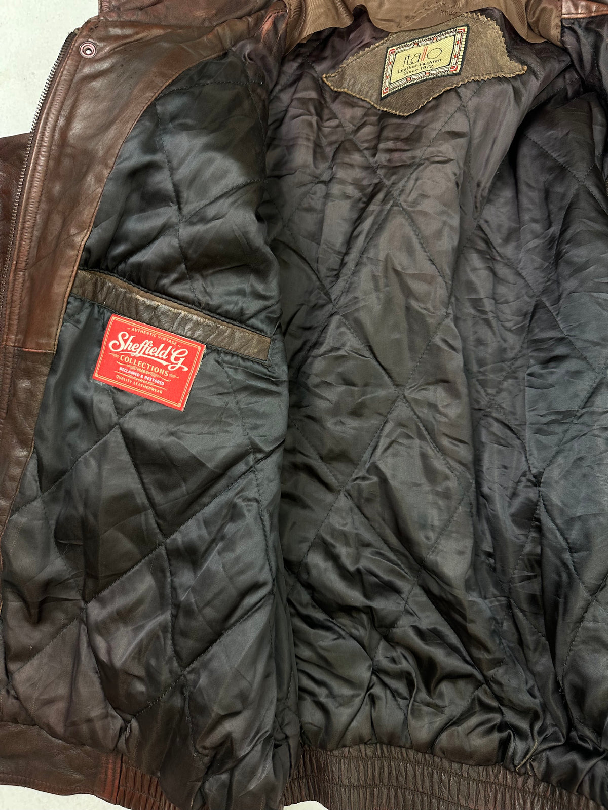 The size L burgundy leather flight jacket opened to show the lining