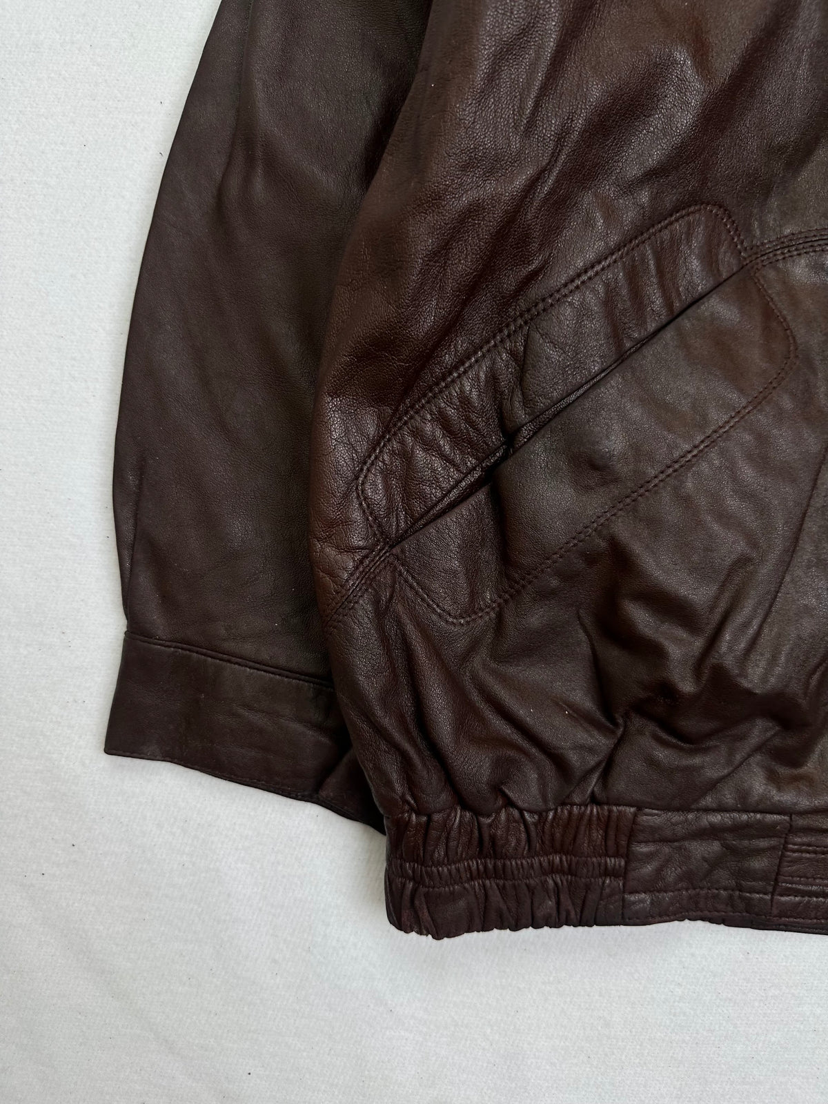 Close detail of the pockets and cuff on the size L burgundy leather flight jacket