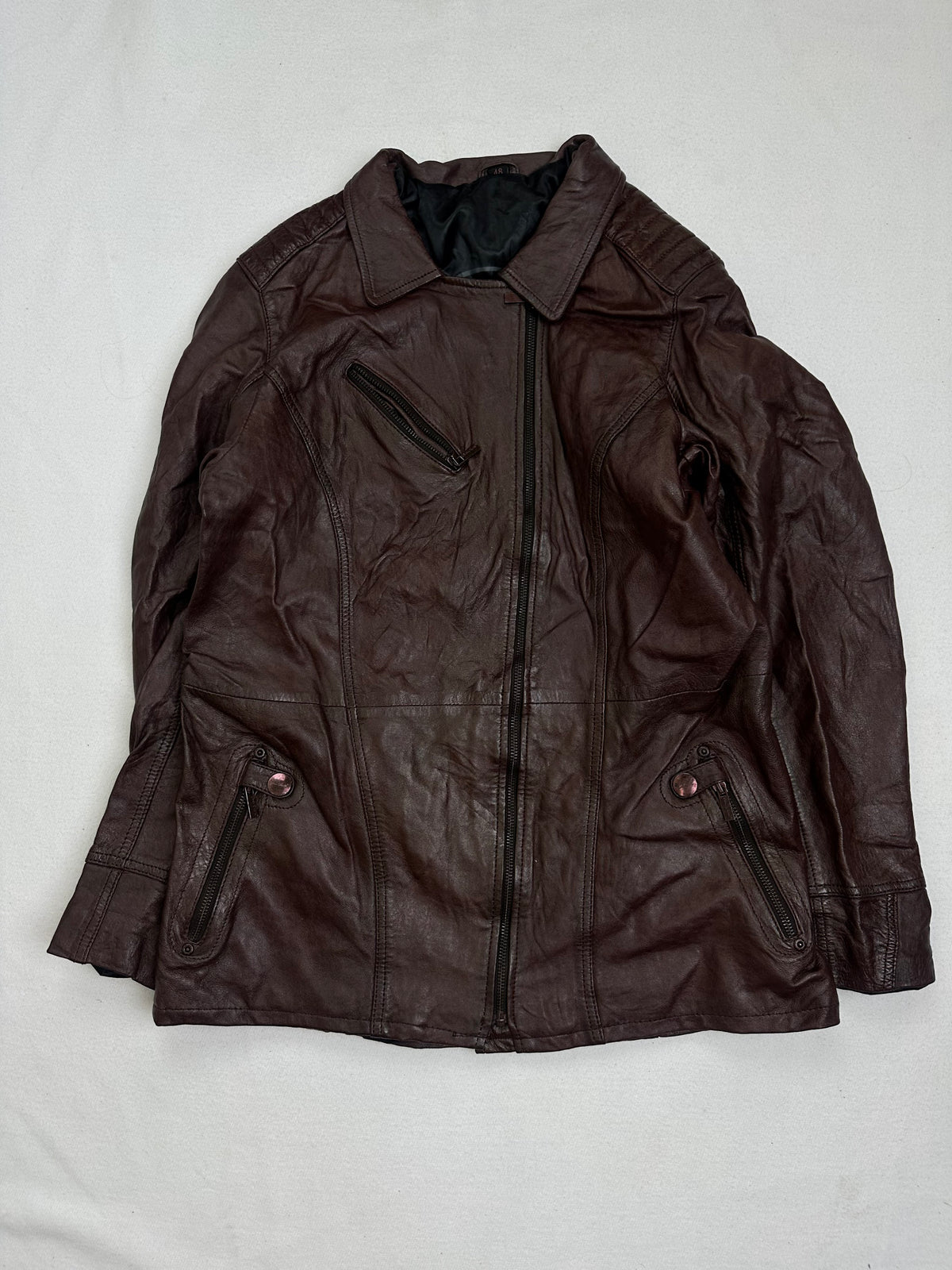 Front of the size M burgundy leather biker jacket, laid flat and unedited