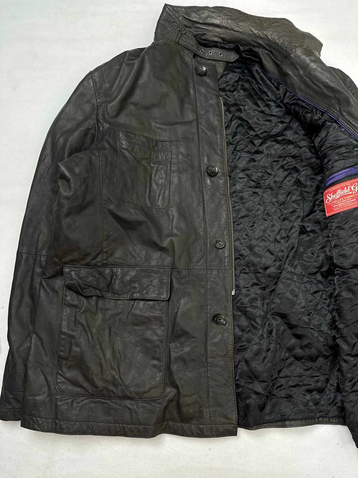 The size XL brown leather field jacket opened to show the lining